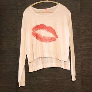 White sweater with red lipstick kiss